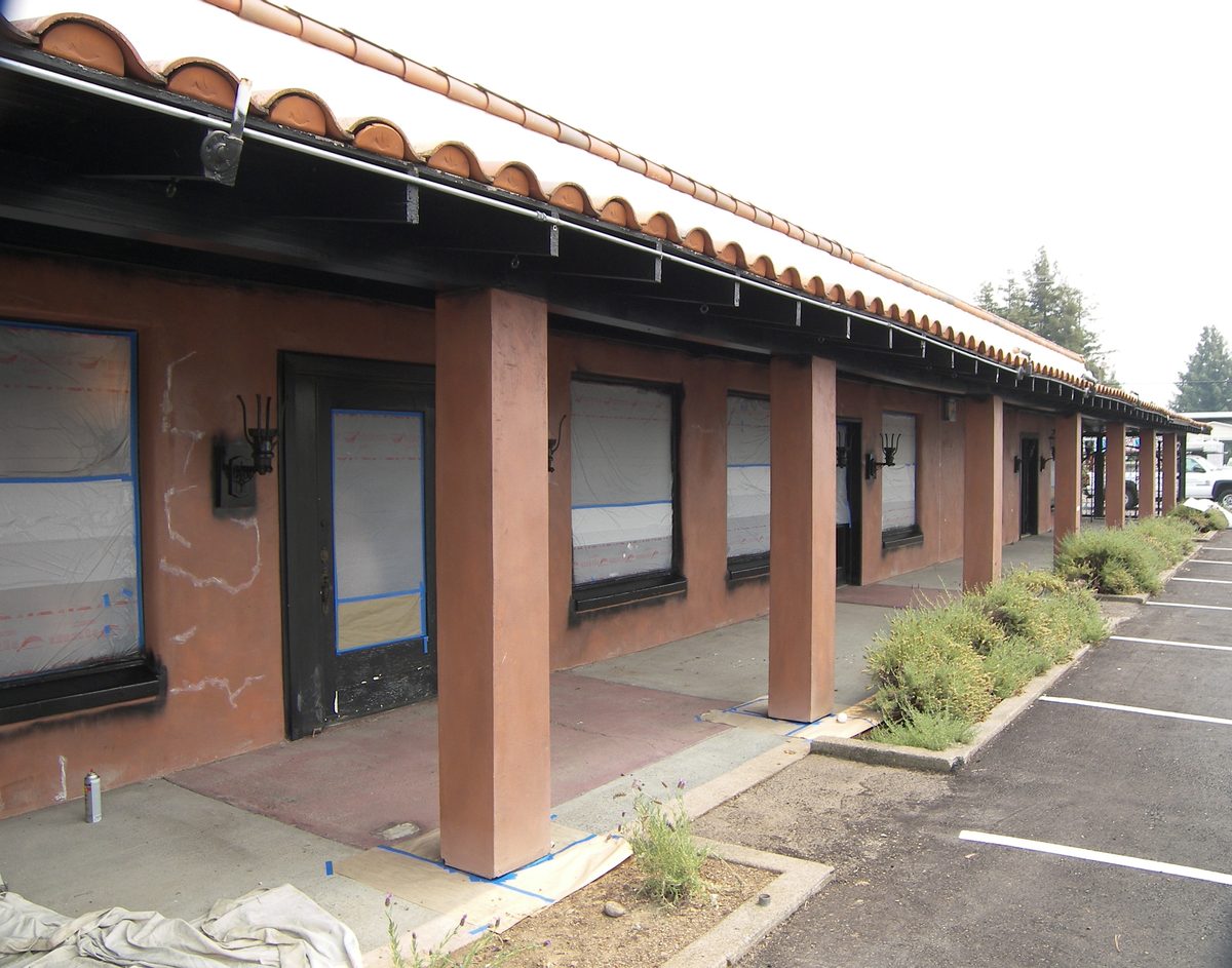 Commercial exterior before repainting, faded and cracked